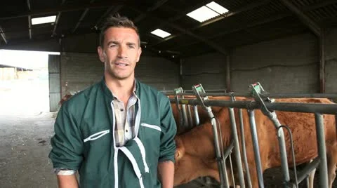 Farmer in barn talking to camera Stock Footage 14833859