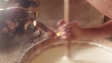 Farmer batters hot fermented sheep's milk in a wooden mortar and fire 스톡 동영상 43225054