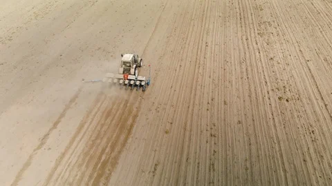 Farmer on a blue tractor with a seeder producing crops in dry sandy soil Vídeos de archivo 117835901