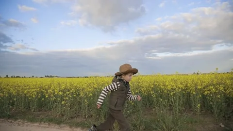 Farmer boy in the hat runs Stock Footage 130243040