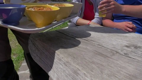 Farmer bringing plate full of bowls with sour milk and buckwheat porridge Stock Footage