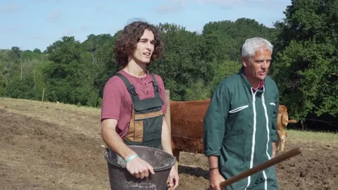 Farmer chatting with a young boy Stock Footage 130369500