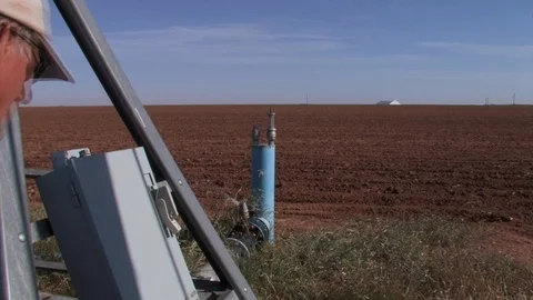 Farmer check irrigation system meter for operation. Stock Footage 88745718
