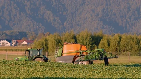 Farmer checking Amazone UX Super trailed sprayer on farming field Stock Footage 163753330