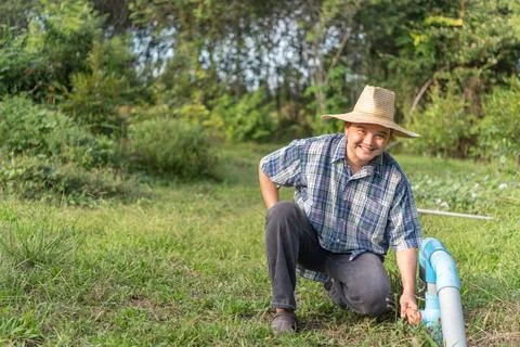 Farmer Checking Irrigation System Stock Photos