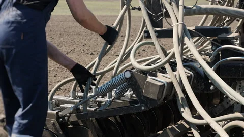 Farmer Checking Seed Tubes On Agricultural Seeder Machine 库存影片 345021837