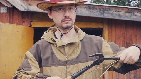 Farmer checks his reaping hook for work Stock Footage 114652112