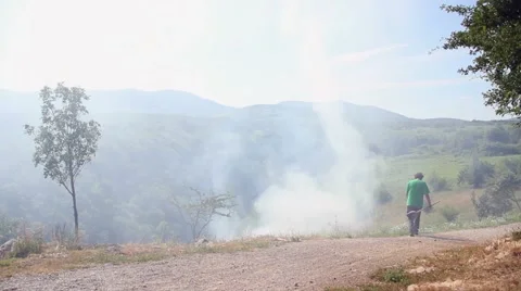 Farmer controlling fire in the countryside Stock Footage 47991707
