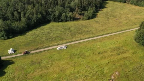 Farmer cuts tall grass in a Swedish wetland filmed from above with drones Vídeos de archivo 161110080