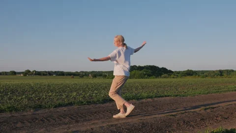 Farmer Dancing Along Field Path in Warm Evening Light Stock Footage 344021257