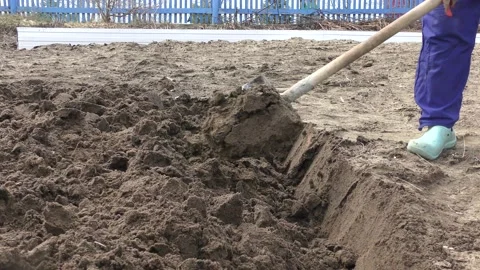 Farmer digging up the ground with a shovel Video stock 196997903