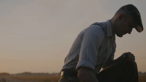 A farmer digs the ground at sunset 4к Stock Footage 113178117