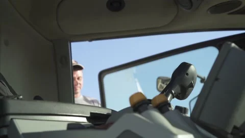 The farmer driver goes inside the combine harvester Stock Footage 139512224