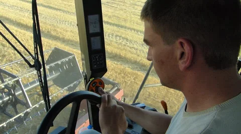 Farmer drives a combine harvester Stock Footage 36015772