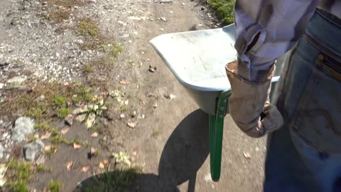 A farmer drives an empty wheelbarrow Video stock 140605236