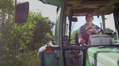 Farmer driving her tractor. Video stock 63024930