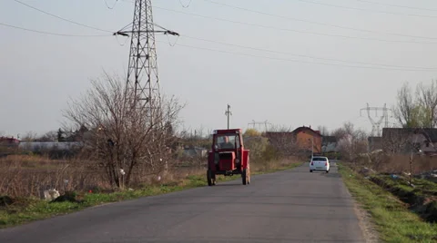 Farmer driving an old tractor on o rural road, village, agriculture, farming Stock Footage 36778837