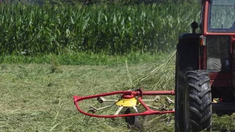Farmer driving tedder Stock Footage 113570546