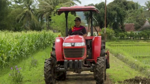 Farmer is driving a tractor Stock Footage 236900351