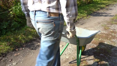 The farmer is driving a wheelbarrow Stock Footage 140455780