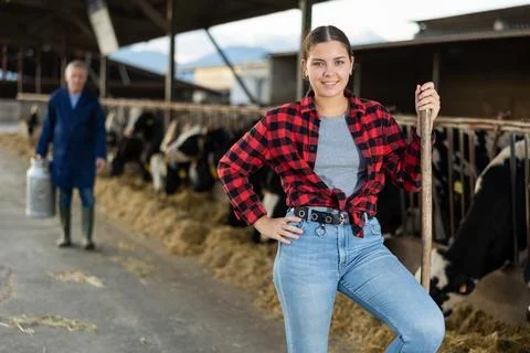 Farmer engaged in breeding of cows posing in cowshed Stock-Fotos