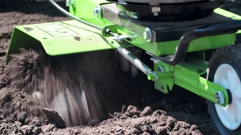 The farmer is engaged in loosening the soil using a motor cultivator. Vídeos de archivo 241066018