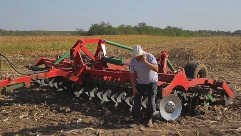 Farmer on the field talking on the phone Stock Footage 96027367