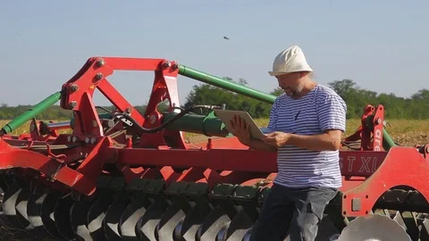 Farmer on the field working on a laptop Stock Footage 96027694