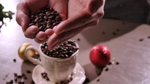 Farmer Hands hold Roasted Coffee Beans. Coffee grains in palm. 動画素材 120556765