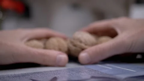 Farmer Hands Picking Walnut Fruits in Shell on the Table. Close-up Stock Footage 224669164