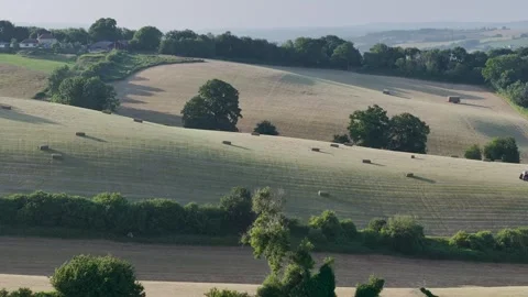 Farmer harvests hay with a tractor in the fields of Devon, Torquay, England Stock Footage 311706513