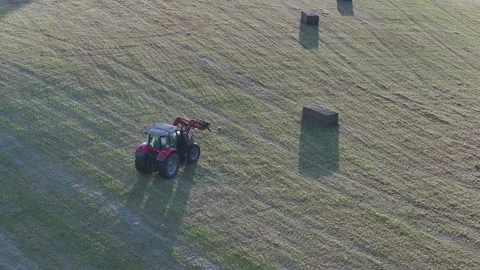 Farmer harvests hay with a tractor in the fields of Devon, Torquay, England Stockbeeldmateriaal 311707036