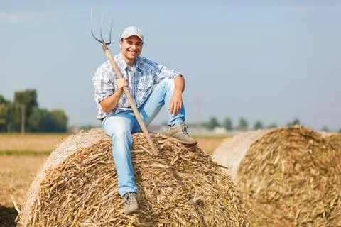 Farmer holding a pitchfork Photos