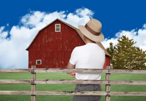 Farmer looking at a red barn Stock Photos
