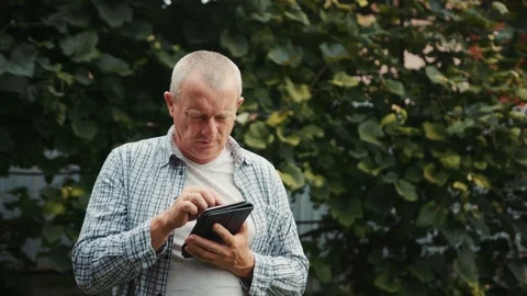 Farmer man with glasses use tablet computer stand grapes traceability and Stock Footage 102778770