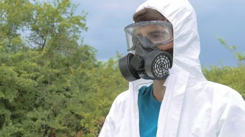 Farmer man in protective clothes prepare pesticides chemicals for plant spray Stock Footage 71540020