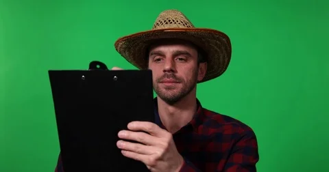 Farmer Man Worker Taking Notes Clip Board Watch Look Out Green Screen Background Video stock 73590079