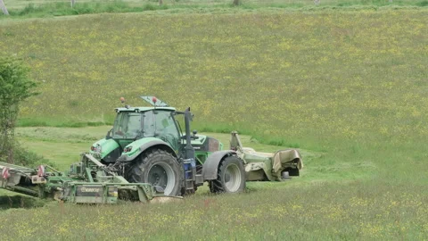 Farmer mowing a field for hay using agricultural machinery 01. 4K locked tripod Stock Footage 154909993