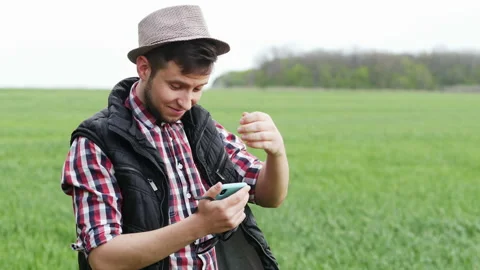 Farmer or agronomist cannot understand mobile phone program for agricultural Stock Footage 142432213