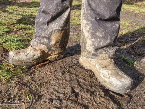 Farmer outdoor boot covered with mud Stock Photos