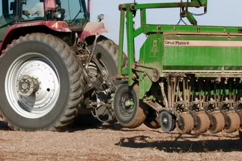 Farmer planting crop with tractor Stock Footage