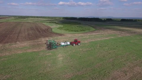 Farmer plowing a field with a tractor Stock Footage 78156062