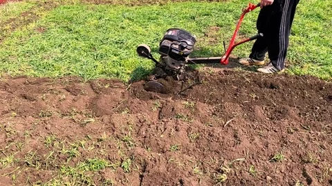 Farmer plowing soil with plowing machine Stock Footage 152854344