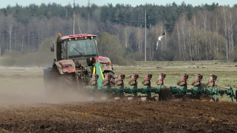 Farmer plows farmland in the spring Stock Footage 154834665