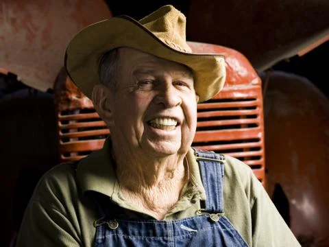 Farmer posing with his tractor Stock Photos