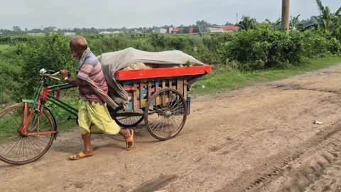 Farmer Pulling Three Wheeled Van With Harvested Vegetables On Rural Road Stock Footage 337389494