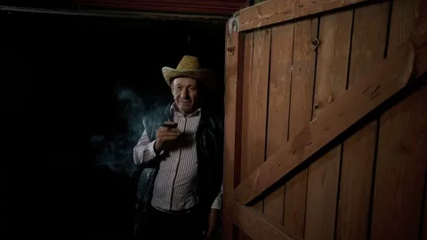 Farmer is resting in the evening over a good cigar. Senior reflects in smoke. Stock-Footage 139066006