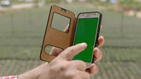 Farmer running a remote irrigation system. Stock Footage 154307799