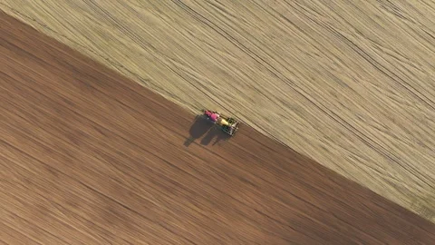 Farmer seeding field with tractor and seed drill during spring season Video stock 310334147