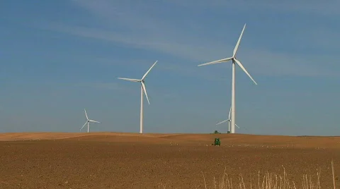 Farmer Seeding His Fields Amongst Wind Turbines  Stock Footage 667540